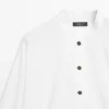 Chemise à col montant avec boutons dorés Chemise à col montant avec boutons dorés
