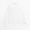 Chemise à col montant avec boutons dorés Chemise à col montant avec boutons dorés