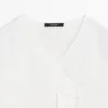 Chemise fluide avec détail sur la poitrine Chemise fluide avec détail sur la poitrine