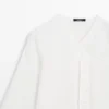 Chemise fluide avec détail sur la poitrine Chemise fluide avec détail sur la poitrine
