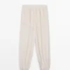 Pantalon sarouel fluide avec détails plissés Pantalon sarouel fluide avec détails plissés