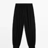 Pantalon sarouel semi-transparent avec boutons Pantalon sarouel semi-transparent avec boutons